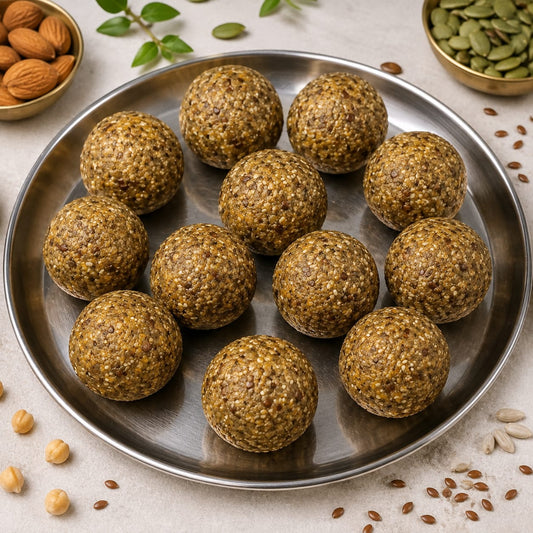 Healthy energy balls made with nutritious seeds and superfoods on a metal plate.