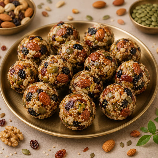 Nutritious energy balls made with mixed seeds, nuts, and dried fruits on a golden plate.