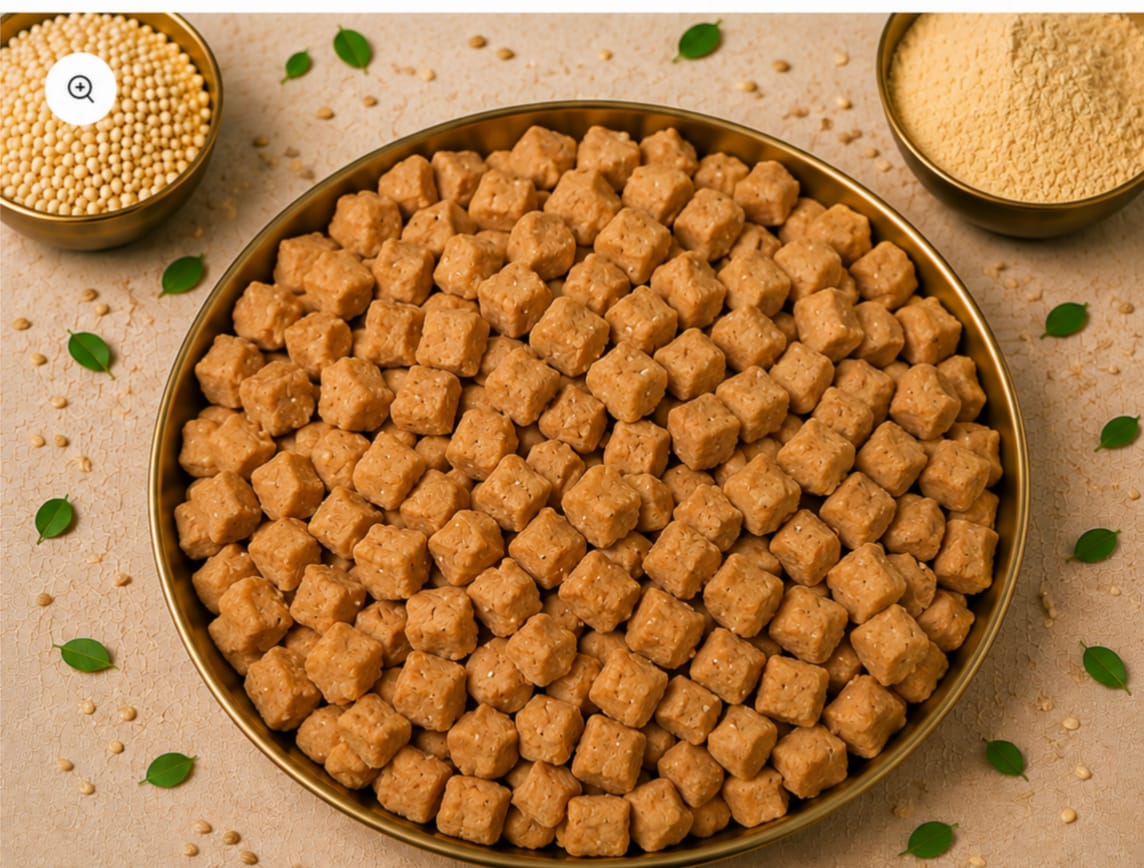 Golden roasted makhana snacks in a brass bowl with seeds and powder.
