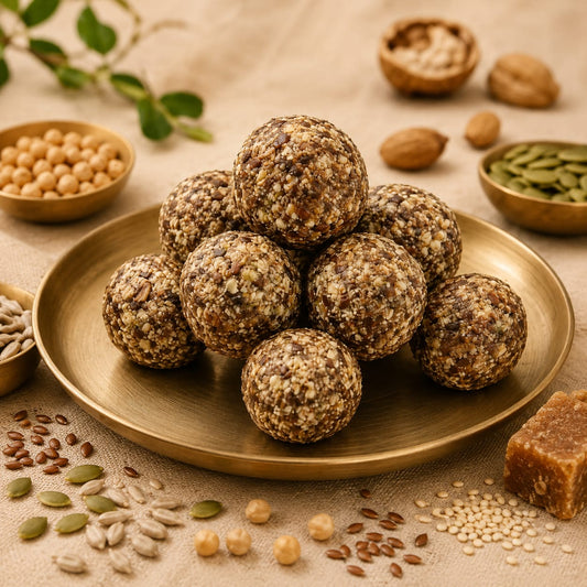 Healthy energy balls made with seeds and nuts served on a brass plate.